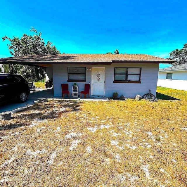 3015 Ave I NW, Winter Haven, FL 33881 - view of front facade with a carport and a front lawn