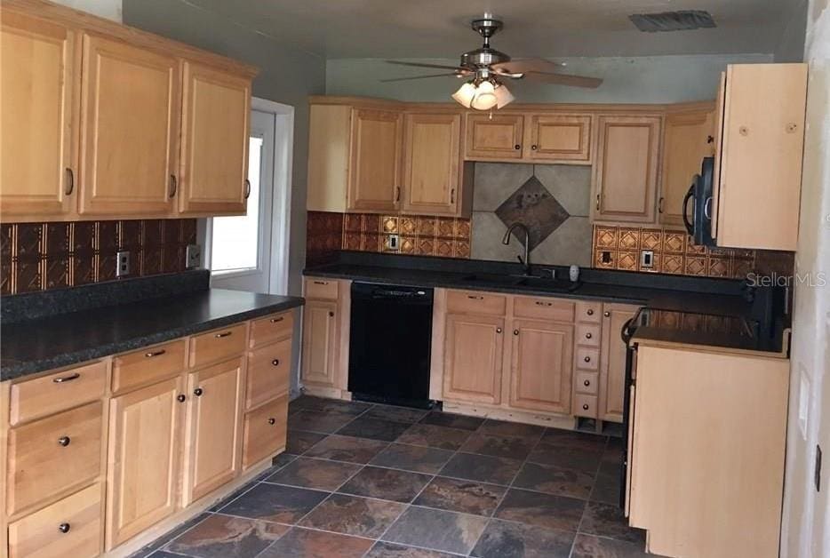 3015 Ave I NW, Winter Haven, FL 33881 - kitchen featuring a sink, black appliances, ceiling fan, light brown cabinets, and dark countertops