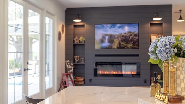 living room featuring a glass covered fireplace