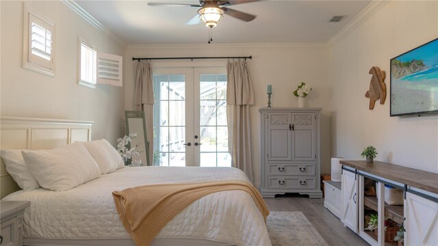 bedroom with crown molding, visible vents, wood finished floors, access to outside, and french doors
