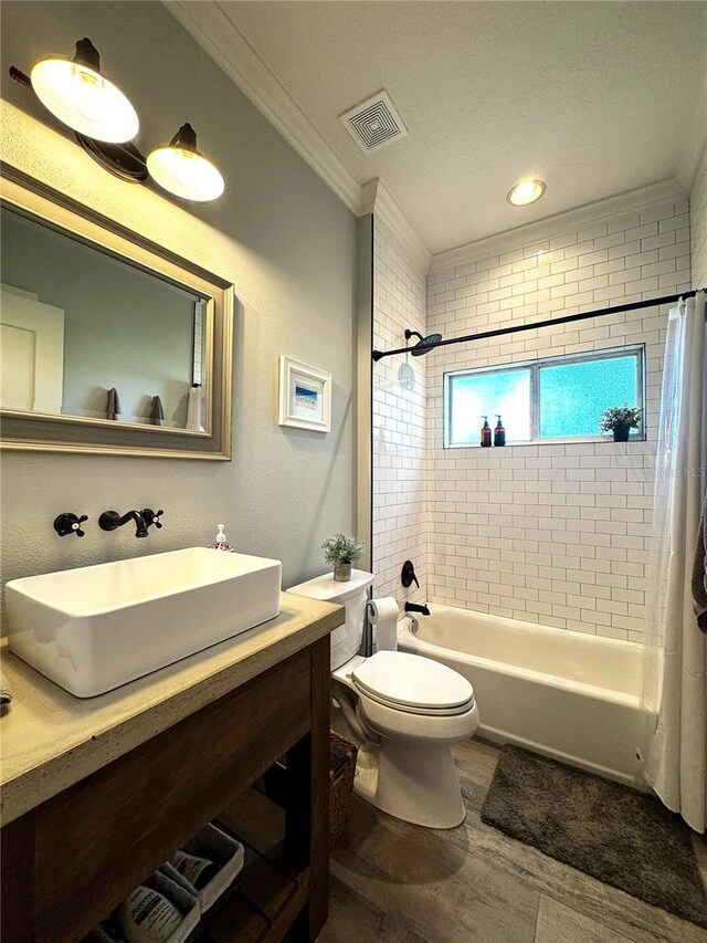 full bath with visible vents, ornamental molding, vanity, shower / bath combination with curtain, and toilet