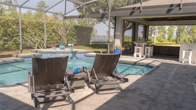 pool featuring a gazebo, glass enclosure, a patio area, and outdoor dry bar