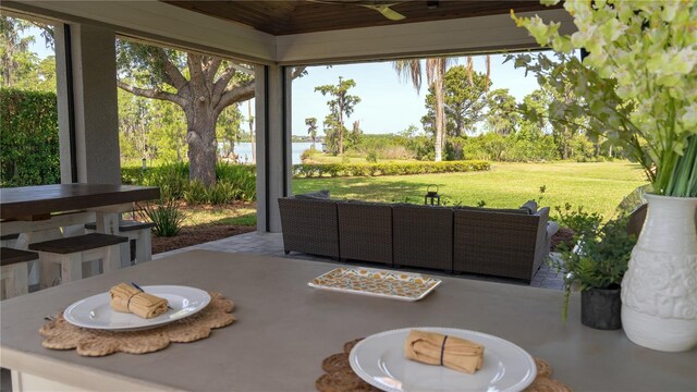 sunroom / solarium featuring ceiling fan, outdoor lounge area, and a wealth of natural light