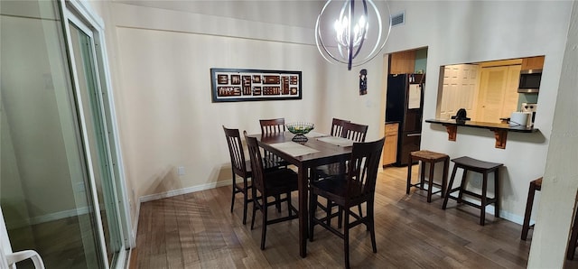 dining room featuring an inviting chandelier, baseboards, dark wood-type flooring, and visible vents