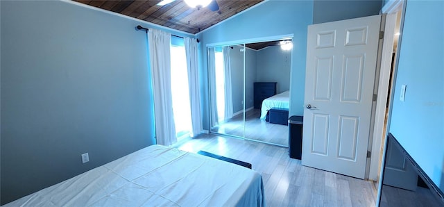 unfurnished bedroom featuring light wood-style floors, wooden ceiling, a closet, and lofted ceiling