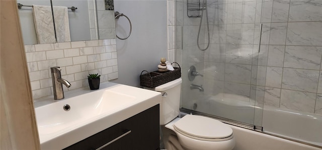 full bathroom with backsplash, toilet, combined bath / shower with glass door, and vanity