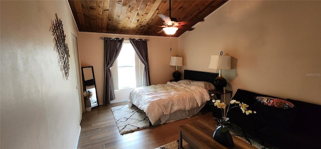 bedroom with a ceiling fan, wood ceiling, lofted ceiling, and wood finished floors