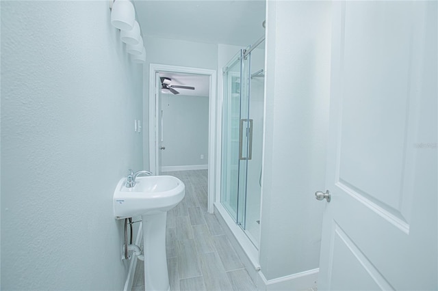 2501 Stratford Dr, Cocoa, FL 32926 - full bathroom featuring a stall shower, a ceiling fan, baseboards, and a sink