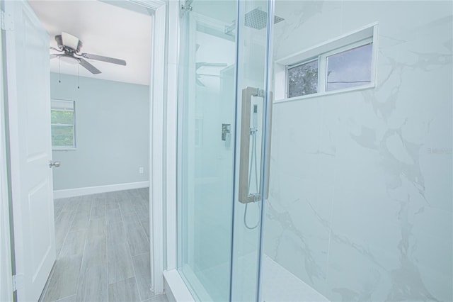 2501 Stratford Dr, Cocoa, FL 32926 - bathroom featuring a marble finish shower, a ceiling fan, and baseboards