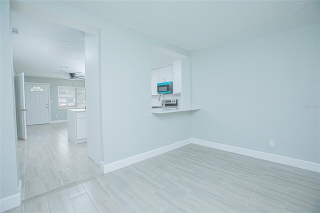 2501 Stratford Dr, Cocoa, FL 32926 - spare room with ceiling fan, baseboards, and wood finish floors