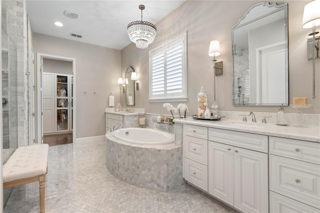 full bathroom featuring a bath, visible vents, a shower stall, vanity, and a notable chandelier