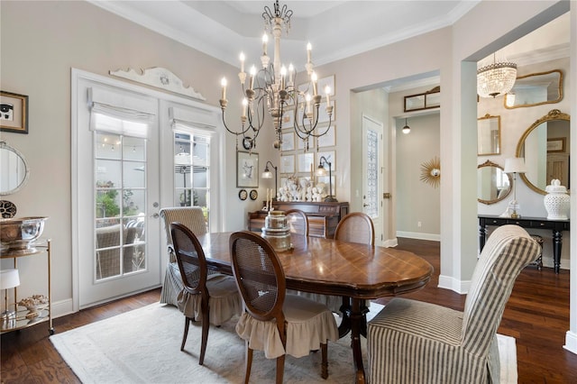 dining area with an inviting chandelier, baseboards, crown molding, and wood finished floors