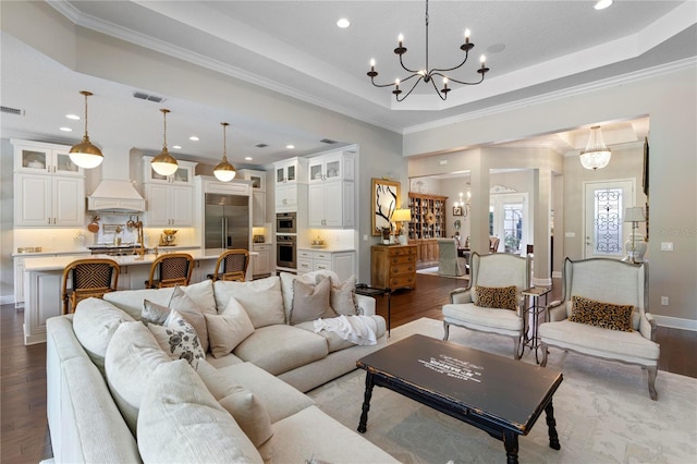living room with dark wood-type flooring, recessed lighting, and an inviting chandelier