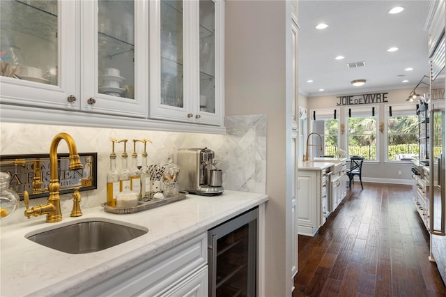 bar with visible vents, decorative backsplash, wine cooler, dark wood-style floors, and a sink