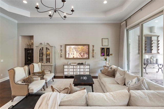 living area featuring recessed lighting, a raised ceiling, wood finished floors, and a chandelier