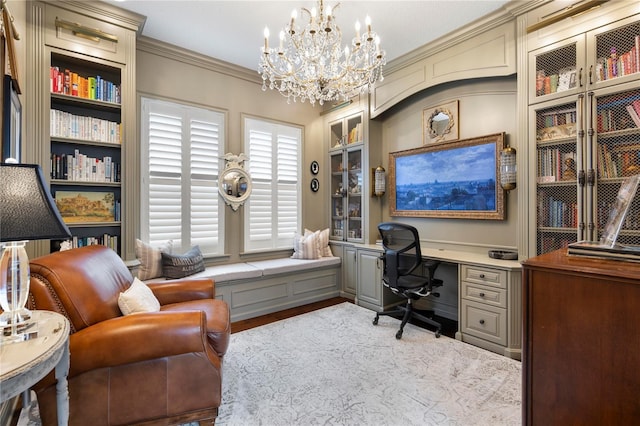office area featuring crown molding, an inviting chandelier, built in study area, built in features, and wood finished floors