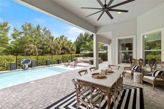 view of patio / terrace with a fenced in pool, ceiling fan, fence, and an outdoor hangout area