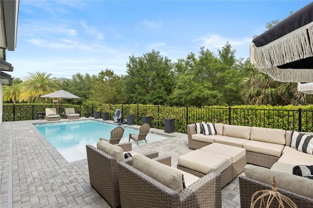 view of swimming pool featuring a fenced in pool, outdoor lounge area, fence, and a patio area