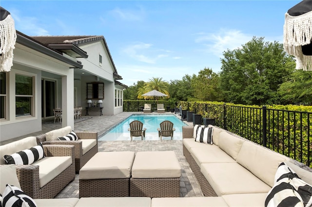 view of swimming pool with an outdoor hangout area, a fenced in pool, a fenced backyard, and a patio