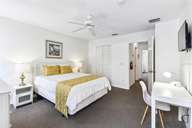 1180 S Beach Cir, Kissimmee, FL 34746 - bedroom featuring dark carpet, a closet, a ceiling fan, and baseboards