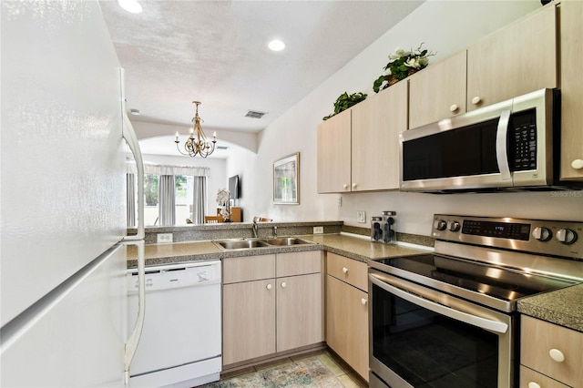 1180 S Beach Cir, Kissimmee, FL 34746 - kitchen with stainless steel appliances, a sink, light brown cabinets, a chandelier, and recessed lighting