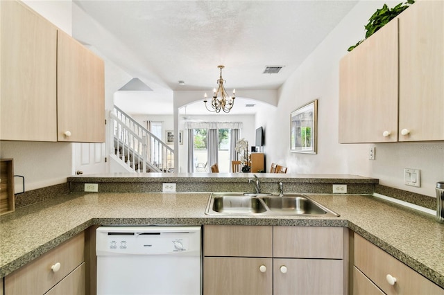 1180 S Beach Cir, Kissimmee, FL 34746 - kitchen with white dishwasher, light brown cabinets, a sink, a chandelier, and a peninsula
