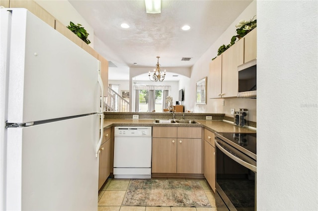 1180 S Beach Cir, Kissimmee, FL 34746 - kitchen with stainless steel appliances, a sink, light brown cabinets, a chandelier, and recessed lighting