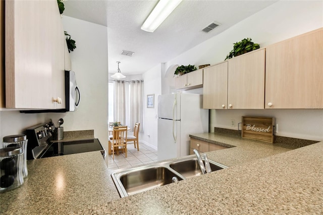 1180 S Beach Cir, Kissimmee, FL 34746 - kitchen featuring appliances with stainless steel finishes, light brown cabinetry, and a sink