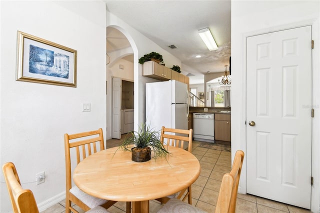 1180 S Beach Cir, Kissimmee, FL 34746 - dining room with baseboards, light tile patterned floors, and arched walkways