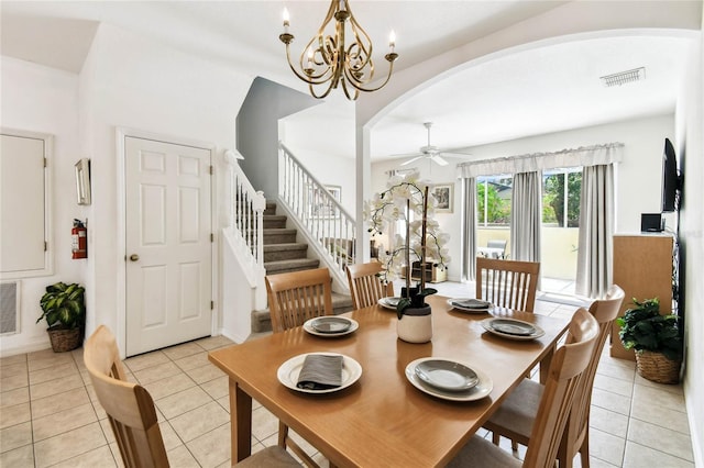 1180 S Beach Cir, Kissimmee, FL 34746 - dining area with arched walkways, a ceiling fan, light tile patterned flooring, stairs, and a chandelier
