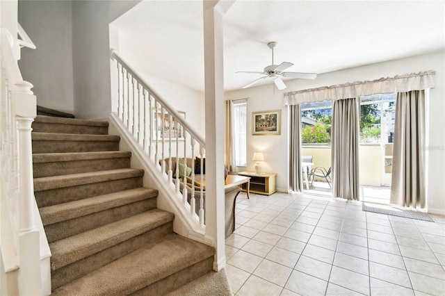 1180 S Beach Cir, Kissimmee, FL 34746 - stairway featuring a ceiling fan, tile patterned floors, and baseboards