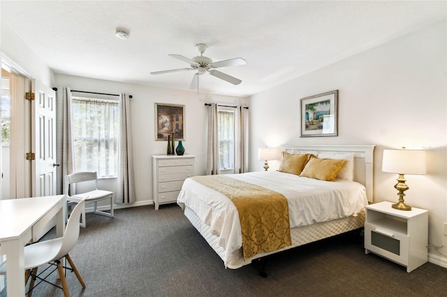 1180 S Beach Cir, Kissimmee, FL 34746 - bedroom featuring multiple windows, dark colored carpet, ceiling fan, and baseboards