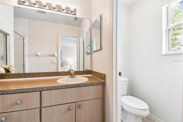 1180 S Beach Cir, Kissimmee, FL 34746 - bathroom featuring vanity, toilet, and a shower with shower door