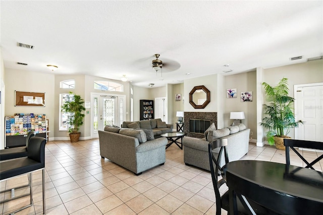 1180 S Beach Cir, Kissimmee, FL 34746 - living area with light tile patterned floors, a ceiling fan, a premium fireplace, and baseboards