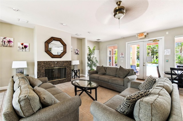 1180 S Beach Cir, Kissimmee, FL 34746 - living room with light tile patterned floors, a fireplace, ceiling fan, baseboards, and french doors