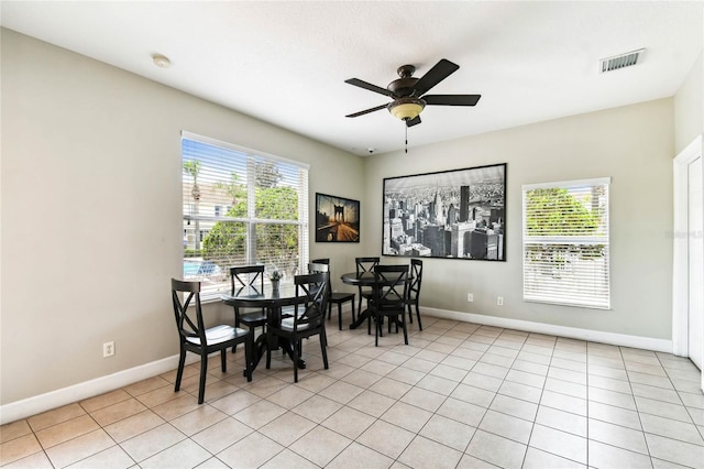 1180 S Beach Cir, Kissimmee, FL 34746 - dining area with healthy amount of natural light, baseboards, a ceiling fan, and light tile patterned floors