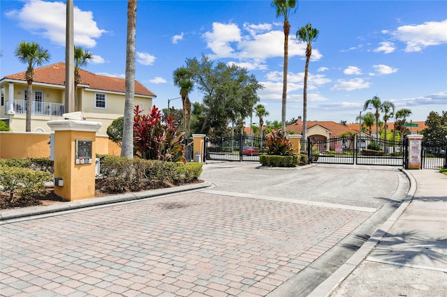 1180 S Beach Cir, Kissimmee, FL 34746 - view of decorative street featuring curbs, a gate, and a gated entry