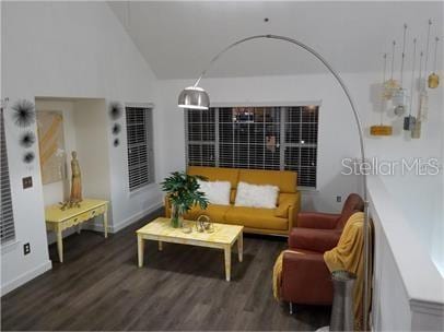 8973 Lee Vista Blvd Unit 2308, Orlando, FL 32829 - living room featuring wood finished floors, baseboards, and lofted ceiling