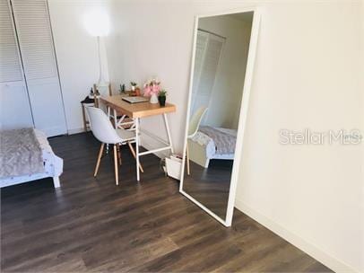 8973 Lee Vista Blvd Unit 2308, Orlando, FL 32829 - bedroom with baseboards and dark wood-type flooring