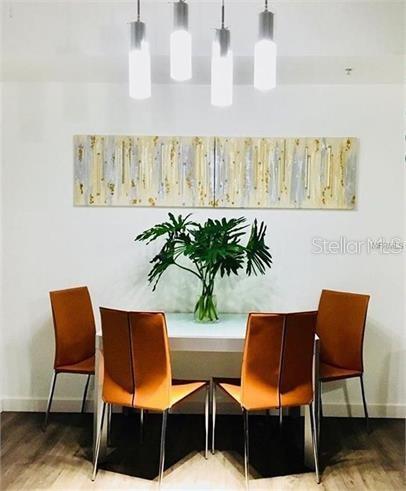 8973 Lee Vista Blvd Unit 2308, Orlando, FL 32829 - dining room featuring baseboards and wood finished floors