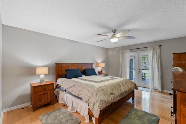 bedroom featuring french doors, a textured ceiling, access to exterior, light wood-type flooring, and baseboards