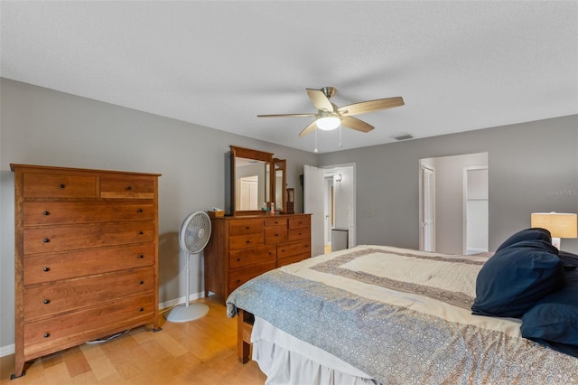 bedroom featuring baseboards, visible vents, ceiling fan, and light wood-type flooring