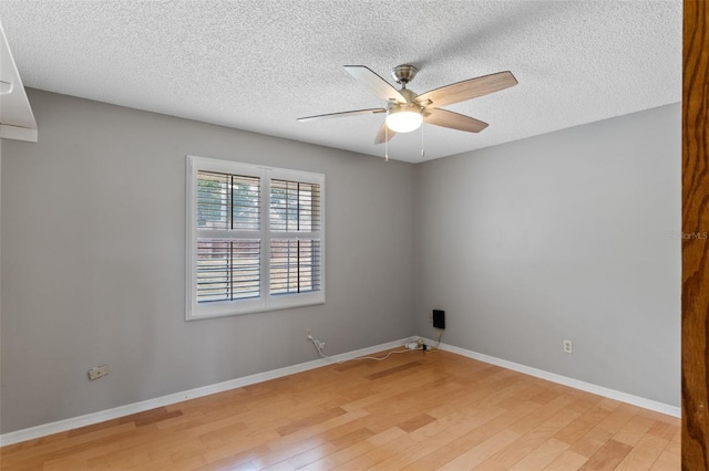 unfurnished room with a textured ceiling, baseboards, a ceiling fan, and light wood-style flooring