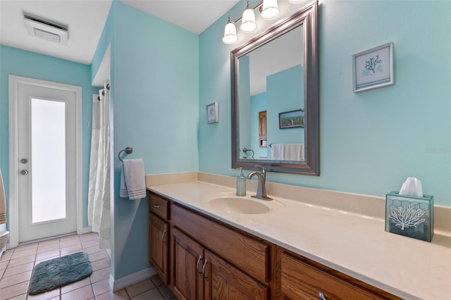 full bath with vanity, tile patterned flooring, baseboards, and visible vents