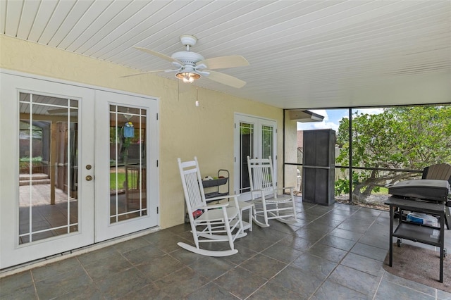 sunroom / solarium featuring french doors