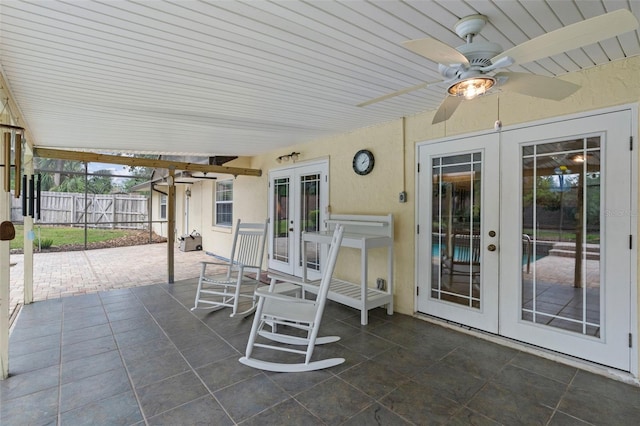 view of patio / terrace with french doors, fence, and ceiling fan