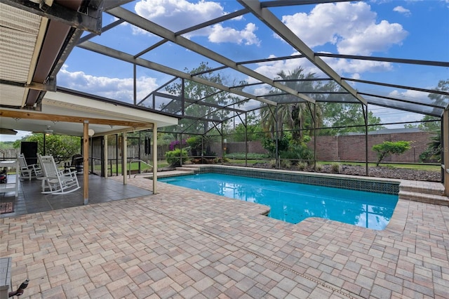 outdoor pool with a patio, a fenced backyard, and a lanai