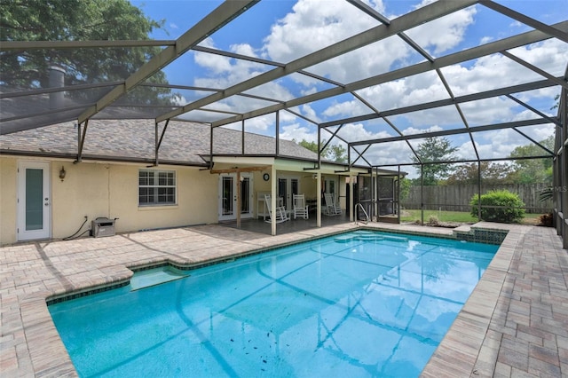 view of pool with a lanai, french doors, a fenced in pool, fence, and a patio