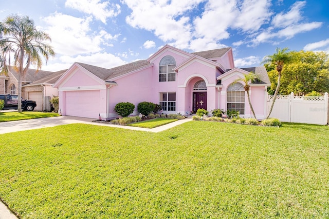 2712 Rolling Broak Dr, Orlando, FL 32837 - view of front of house featuring stucco siding, fence, driveway, and a front yard