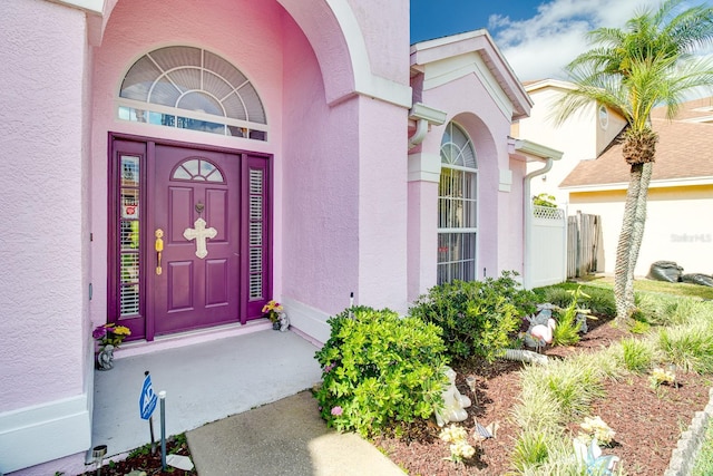 2712 Rolling Broak Dr, Orlando, FL 32837 - doorway to property featuring fence and stucco siding